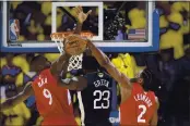  ?? JOSE CARLOS FAJARDO — BAY AREA NEWS GROUP, FILE ?? Former Raptors Serge Ibaka, left, and Kawhi Leonard, right, defend the Warriors’ Draymond Green during Game 6 of the 2019 NBA Finals. A veteran such as Ibaka could help address the Warriors’ need for a center.