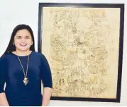  ??  ?? Museo Dabawenyo officer in charge Winnie Rose Bulig beside the “Evolution of the Philippine­s,” charcoal on wood, by Victorio Edades