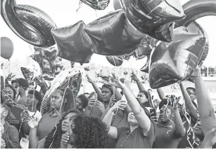  ??  ?? August 27 2018 - Classmates, teammates, friends and family release balloons in honor of Dennis Mitchell at the Byhalia High School football field. Mitchell,Êa sophomore football player, collapsed on the field and died Friday night during a game. BRAD VEST/THE COMMERCIAL APPEAL,