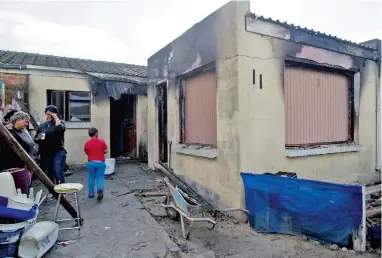  ?? PICTURES: HENK KRUGER ?? SAD SCENE: Chantal Davids and her boyfriend Christophe­r Fredericks died after their Lentegeur home was gutted by a fire. Fortunatel­y, their three children – aged 1, 5 and 10 – were saved.