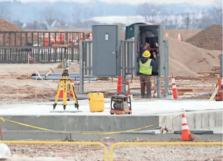  ?? MIKE DE SISTI / MILWAUKEE JOURNAL SENTINEL ?? A crew member works this month at the American Transmissi­on Co. substation near the Foxconn factory site in Mount Pleasant. The substation is part of a $117 million project to provide electrical service to the Foxconn campus.