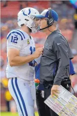  ?? MARK TENALLY/ASSOCIATED PRESS ?? Indianapol­is Colts head coach Frank Reich, right, talks with Andrew Luck during the Colts’ win Sunday, which was Reich’s first victory.