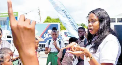  ?? ?? Joanie James of the Bureau of Gender Affairs shares informatio­n on gender-based violence to students of Tarrant Primary School at the launch of the Domestic Violence Interventi­on Cross Country Tour held on March 12 at the