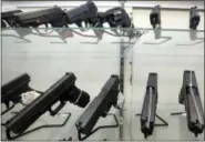  ?? THE ASSOCIATED PRESS ?? Guns are displayed at a gun store in Miami.