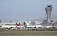  ?? Marcio Jose Sanchez / Associated Press ?? Airplanes wait to take off at San Francisco Internatio­nal Airport, where an Air Canada plane nearly landed on a bustling taxiway instead of a runway Friday.