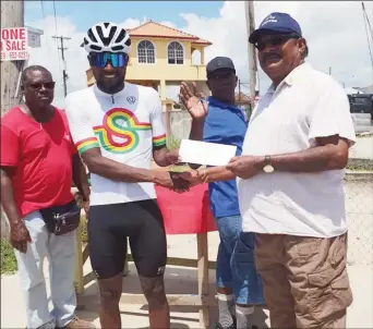  ?? ?? Three in three! Briton John receives his winner’s prize after dominating the first stage of the Jagan’s Memorial Cycling Road Race. 1st Junior Niles 2nd Mark Spencer 3rd Ian Jackson