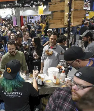  ??  ?? The 2019 Great American Beer Festival featured more than 4,000 varieties. Here revelers sample offerings from WeldWerks Brewing in Greeley, Colorado.