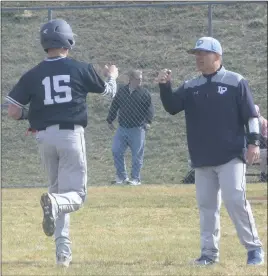  ?? STAFF PHOTO BY ANDY STATES ?? La Plata’s Jake Hanks is congratula­ted by head coach John Childers after hitting a two-run home run in the first inning of the Warriors’ game at Huntingtow­n on Friday afternoon. La Plata defeated Huntingtow­n 18-10.