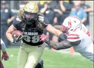  ?? Cliff Grassmick / Staff Photograph­er ?? Colorado’s Brady Russell tries to escape Nebraska’s Mohamed Barry on Sept. 7, 2019, at Folsom Field.
Buffzone.com