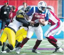  ?? GRAHAM HUGHES/THE CANADIAN PRESS ?? Darian Durant, shown getting sacked in Sunday’s game against the Hamilton Tiger-Cats, has been tapped as the starter for Friday’s game against Saskatchew­an.