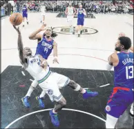  ?? Marcio Jose Sanchez The Associated Press ?? Minnesota guard Anthony Edwards takes an off-balance shot while surrounded by Clippers defenders Terance Mann (14) and Paul George.