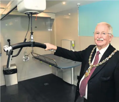  ??  ?? Cheltenham mayor Bernard Fisher looks at the new A2B Ceiling Hoist Pictures: Nick Parford Photograph­y