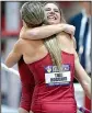  ?? NWA Democrat-Gazette/ ANDY SHUPE ?? Arkansas’ Lexi Jacobus (right) hugs her twin sister Tori Hoggard after winning the pole vault at the SEC Indoor Track and Field Championsh­ips in Fayettevil­le on Saturday. Hoggard finished second.