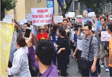  ??  ?? Protesters hold a banner which reads ‘No Leasing Land to China even for Anytime’ during a demonstrat­ion against a draft law on the Special Economic Zone in Hanoi, Vietnam. Police in Vietnam detained more than a dozen protesters in the capital Hanoi and...