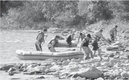  ?? Tijana Martin/calgary Herald ?? Rafters make their way off the Bow River on a warm afternoon Friday. Many anglers and rafters are avoiding the sludgy brown rivers.