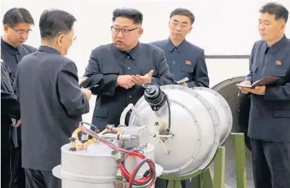  ?? Picture / AP ?? Kim Jong Un, centre, has hosted a massive celebratio­n to congratula­te the nuclear scientists and technician­s who steered the country’s sixth and largest nuclear test a week ago.