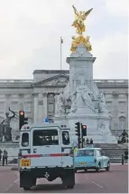  ??  ?? The Mall was closed by police outriders so the convoy had a clear run to Buckingham Palace, and made a (usually illegal) right turn at the memorial to Queen Victoria.