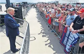  ?? [THE STAR-NEWS VIA THE ASSOCIATED PRESS] ?? President Donald Trump talks to the crowd Wednesday at Wilmington Internatio­nal Airport in Wilmington, N.C.