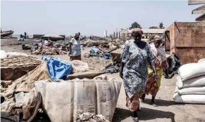  ?? Africa. Photograph: Seyllou/AFP/Getty Images ?? Workers of the fish drying industry in the the deserted fish market in Rufisque, Senegal, 2020.More than £63bn will be spent by the 75 countries, many of them in sub-Saharan