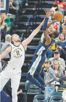  ??  ?? Denver’s Will Barton tries to score against Indiana’s Domantas Sabonis during Sunday’s game in Indianapol­is. Barton finished with 21 points. Sabonis had 14.