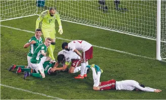  ??  ?? Danger...Robbie Brady of the Republic of Ireland lies injured after a clash of heads against Georgia