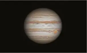  ??  ?? Right: Jupiter’s swirling storms and atmospheri­c bands