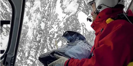  ?? PHOTO: SUPPLIED ?? Bombs away . . . Milford Road Alliance avalanche technician Brad Carpenter holds a bag of explosive material used to set off avalanches yesterday morning ahead of reopening the highway.