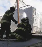  ?? ?? Paterson firefighte­rs along with assistance from mutual aid companies battle a fire on East 18th Street in Paterson on Tuesday.