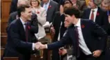  ?? CHRIS WATTIE/REUTERS ?? Justin Trudeau and Bill Morneau are breaking their deficit promise to deliver on other pledges.