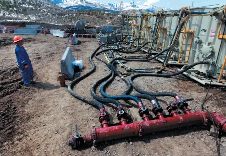  ?? CP FILE PHOTO ?? A worker helps monitor water pumping pressure and temperatur­e at a hydraulic fracturing and extraction site in western Colorado in March 2013.