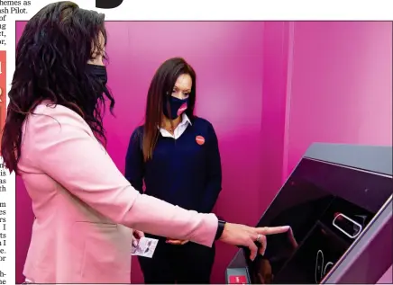  ??  ?? THE FUTURE IS PINK: Angela Finlay of OneBanks shows Gill Jack how to use the kiosk in Kilwinning, Ayrshire