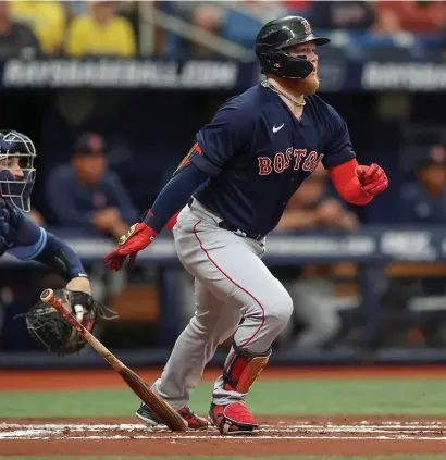  ?? GEtty iMaGEs pHOtOs ?? COMING OUT SWINGING: Alex Verdugo hits an RBI single to score Kike Hernandez, below, during the first inning of the Red Sox’ 5-2 loss to the Tampa Bay Rays on Sunday.