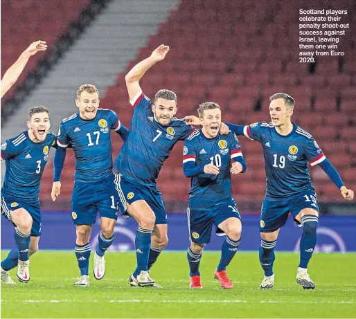  ??  ?? Scotland players celebrate their penalty shoot-out success against Israel, leaving them one win away from Euro 2020.