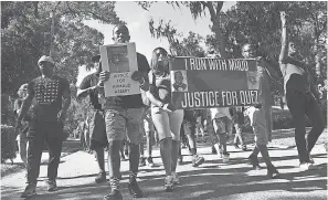  ??  ?? A crowd marches through a neighborho­od in Brunswick, Ga., on Tuesday, demanding answers in the death of Ahmaud Arbery. BOBBY HAVEN/ AP