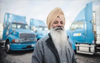  ?? COLE BURSTON THE CANADIAN PRESS ?? Nachhattar Chohan, president of CH Expedite, stands amongst a few of his trucks in Mississaug­a.