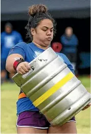  ??  ?? Open women’s winner Shayna Wirihana, of Palmerston North, carries a 90kg weight 63 metres to win the anvil carrying event.