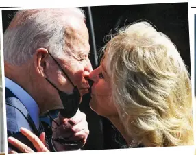  ??  ?? Special relationsh­ip: Biden shares a smooch with wife Jill