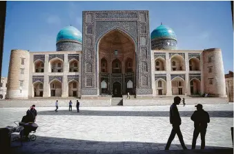  ?? Taylor Weidman / Bloomberg ?? Uzbekistan’s ancient cities still stand remarkably intact — along with their ornate, mosaic-laden monuments, including the Mir-i-Arab Madrasa in Bukhara.