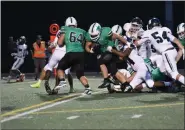  ?? PATRICK HOPKINS — FOR THE NEWS-HERALD ?? Mayfield’s Clay Cunningham, center, carries as Eli Harrison blocks Sept. 13 against visiting Nordonia.