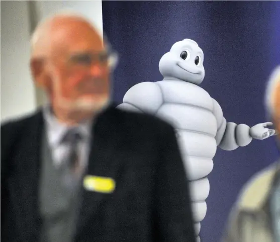  ??  ?? Michelin shareholde­rs leave a meeting. The tyre maker is counting on its brand image in China AFP