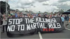  ?? VINCENT GO, AFP/GETTY IMAGES ?? Anti-martial-law protesters march near the House of Representa­tives where President Rodrigo Duterte gave his address.