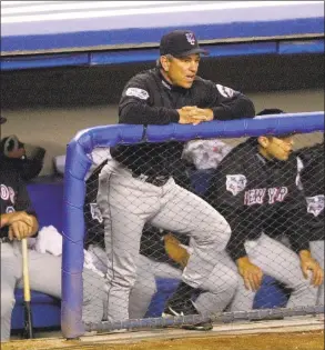  ?? Ron Frehm / Associated Press ?? Mets manager Bobby Valentine, front center, watches Game 1 of the World Series against the Yankees from the top step of the dugout in 2000.