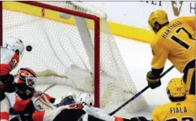  ?? MIKE STRASINGER — THE ASSOCIATED PRESS ?? Predators forward Scott Hartnell (17) scores past Flyers goalie Brian Elliott (37) in the third period Tuesday in Nashville, Tenn.