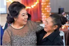  ?? MARK HOFFMAN / MILWAUKEE JOURNAL SENTINEL ?? Blia Cha (left) greets well-wishers during her retirement party Saturday. The Hmong refugee has helped hundreds buy homes in Milwaukee.