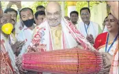  ??  ?? Union Home Minister Amit Shah plays an instrument inside Batadrava Than, the birthplace of Srimanta Sankardev, in Nagaon District of Assam.