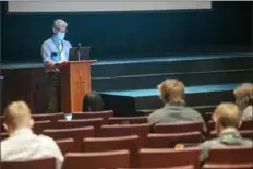  ??  ?? Christophe­r Chapman teaches his sophomore English class in person and virtually Wednesday from inside the Seton LaSalle auditorium.