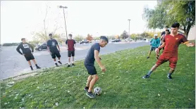  ?? LUIS SÁNCHEZ SATURNO/THE NEW MEXICAN ?? Senior Mario Juarez, left, and junior José Hernández run drills Thursday on a 15 foot wide patch of grass in front of their new building.