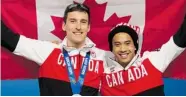  ?? ADRIAN WYLD/The Canadian Press ?? Canadian speedskate­rs Denny Morrison and Gilmore Junio hold a Canadian flag on Sunday in Sochi, Russia. Despitean early lead, Canada is off Vancouver’s medal pace.