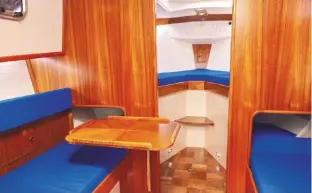  ??  ?? ABOVE The saloon is short but surprising­ly roomy, with a swivelling table that can be swung away into the port trotter-box LEFT A remarkably spacious forecabin for a 25-footer, with a tongue and groove-effect hullside lining