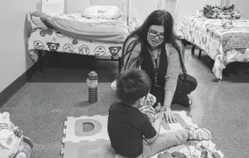  ?? Jerry Lara / Staff file photo ?? Interventi­on specialist Yolanda Luna works with a 2-year-old boy at the Whataburge­r Center for Children in February 2020. The center was among group homes and agencies closed as a result of heightened monitoring.